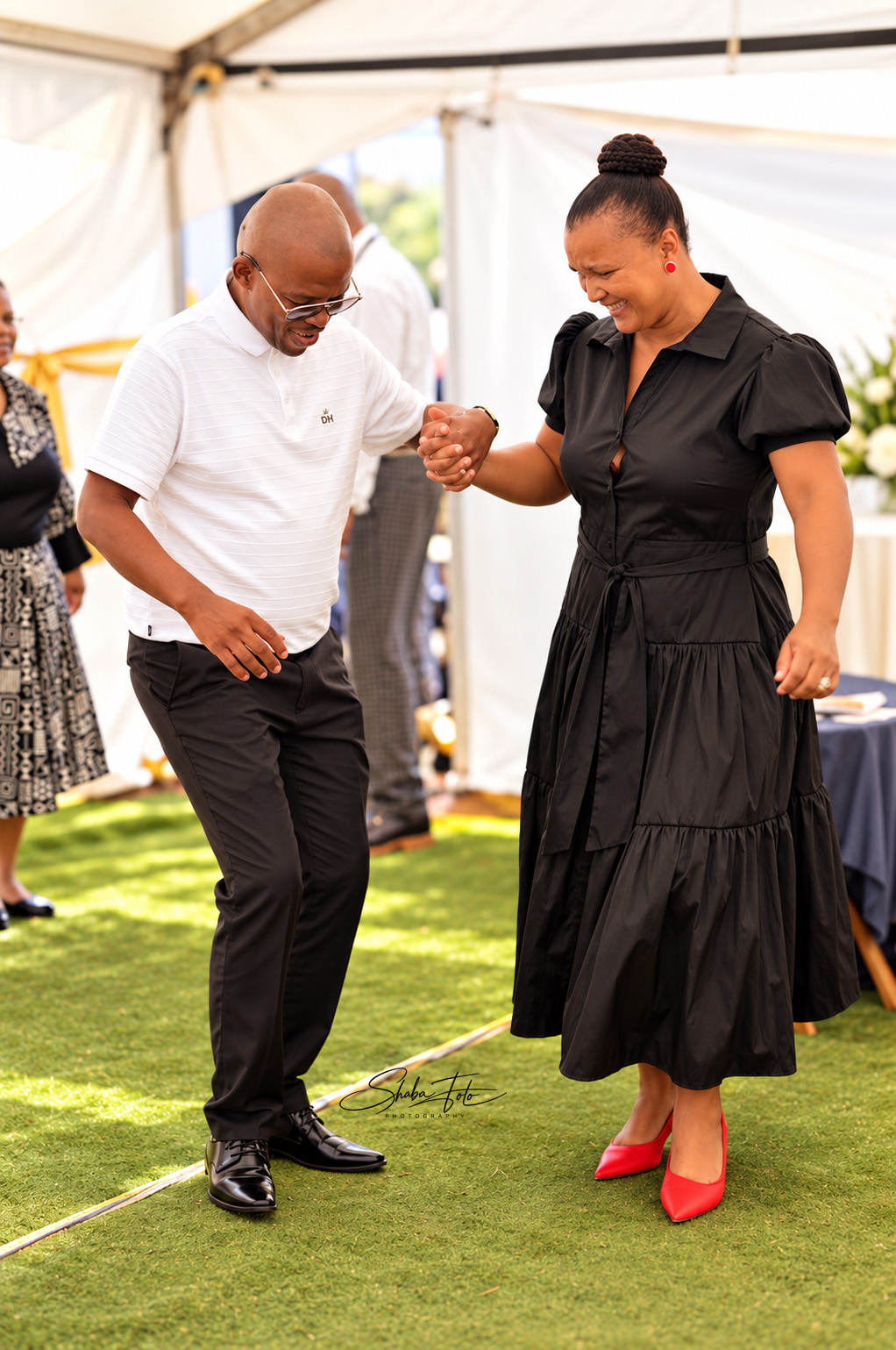Man and woman dancing together at an outdoor celebration
